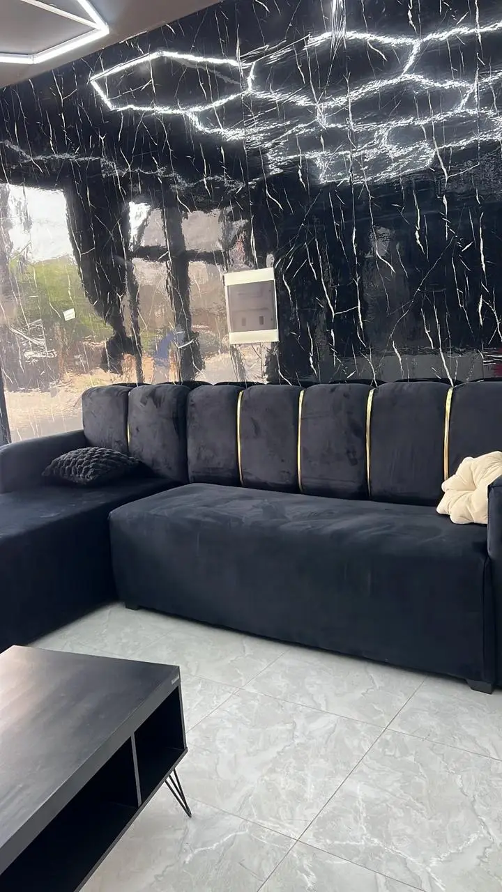 Sofá preto com detalhes dourados